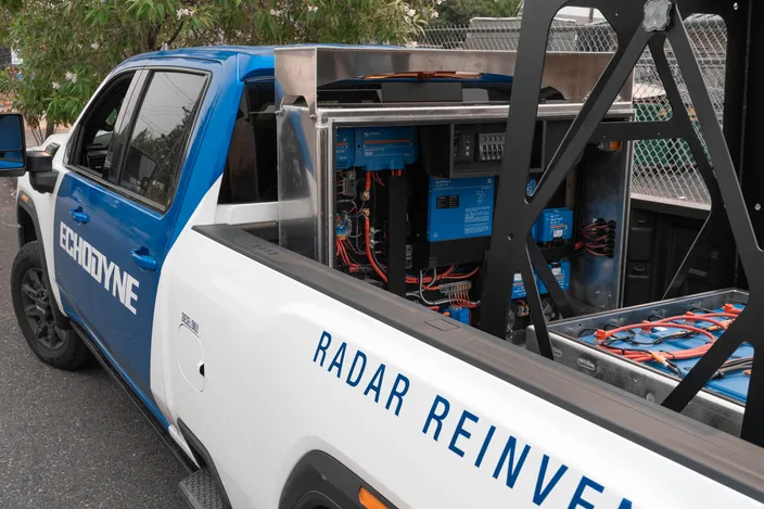 Echodyne radar truck with its battery bank and Victron power equipment exposed in the truck bed.