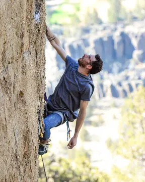 Jordan Burgess rock climbing outdoors.