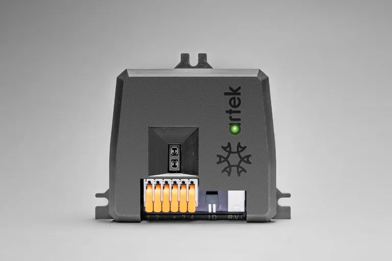 Artek DC load controller in a black enclosure, with orange terminal connectors and a green status indicator.